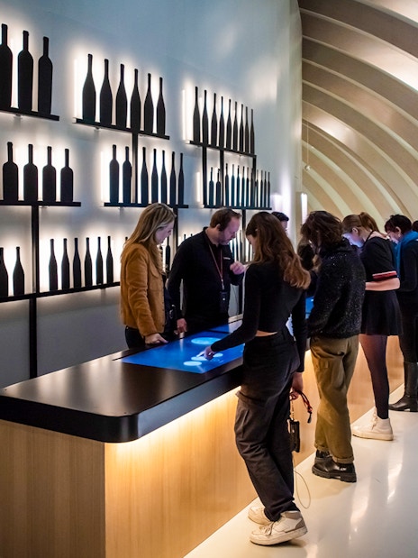 Visitors using interactive displays at Cité du Vin museum, Bordeaux, France.