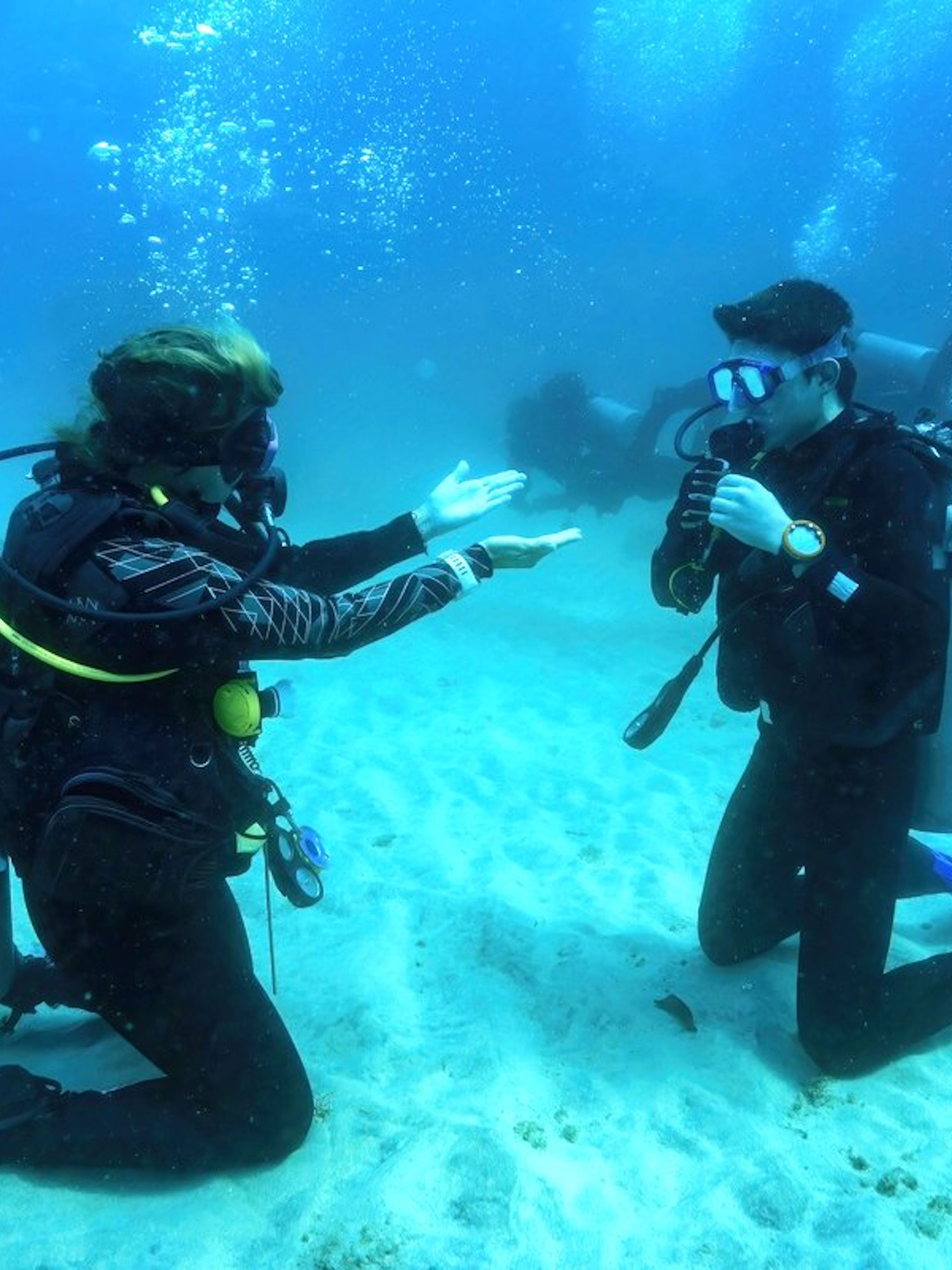 Scuba diving lesson in the Red Sea, Hurghada, with beginners practicing underwater skills.
