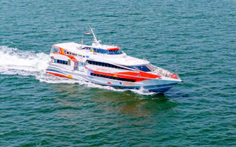 High-speed ferry traveling from Singapore to Batam across the sea.