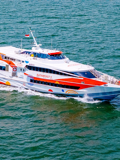 High-speed ferry traveling from Singapore to Batam across the sea.
