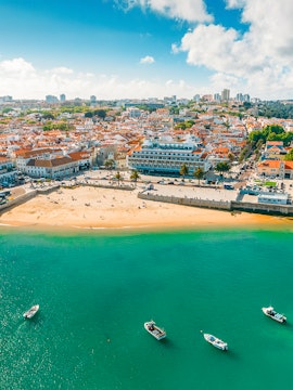 Aerial view of Cascais bay with boats and beach, Portugal.