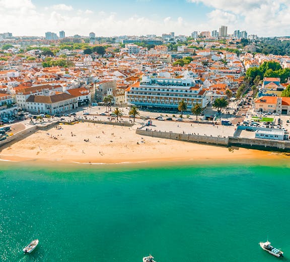Aerial view of Cascais bay with boats and beach, Portugal.