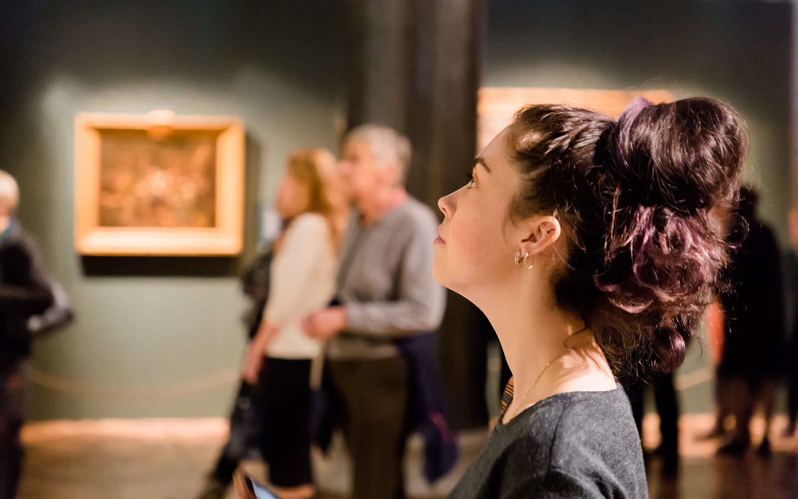 Young women waching arts at the museum. Excursion with group