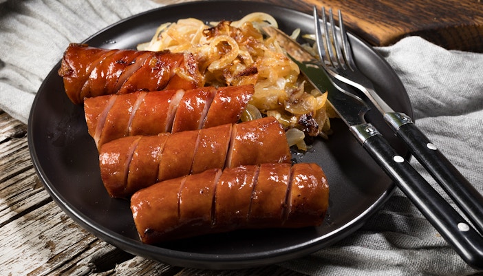 Close up, fried sausage with onion.
