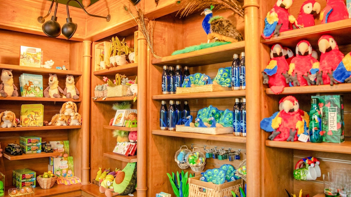 Gift shop shelves with plush animals and souvenirs at Jardin d'Acclimatation, Paris.