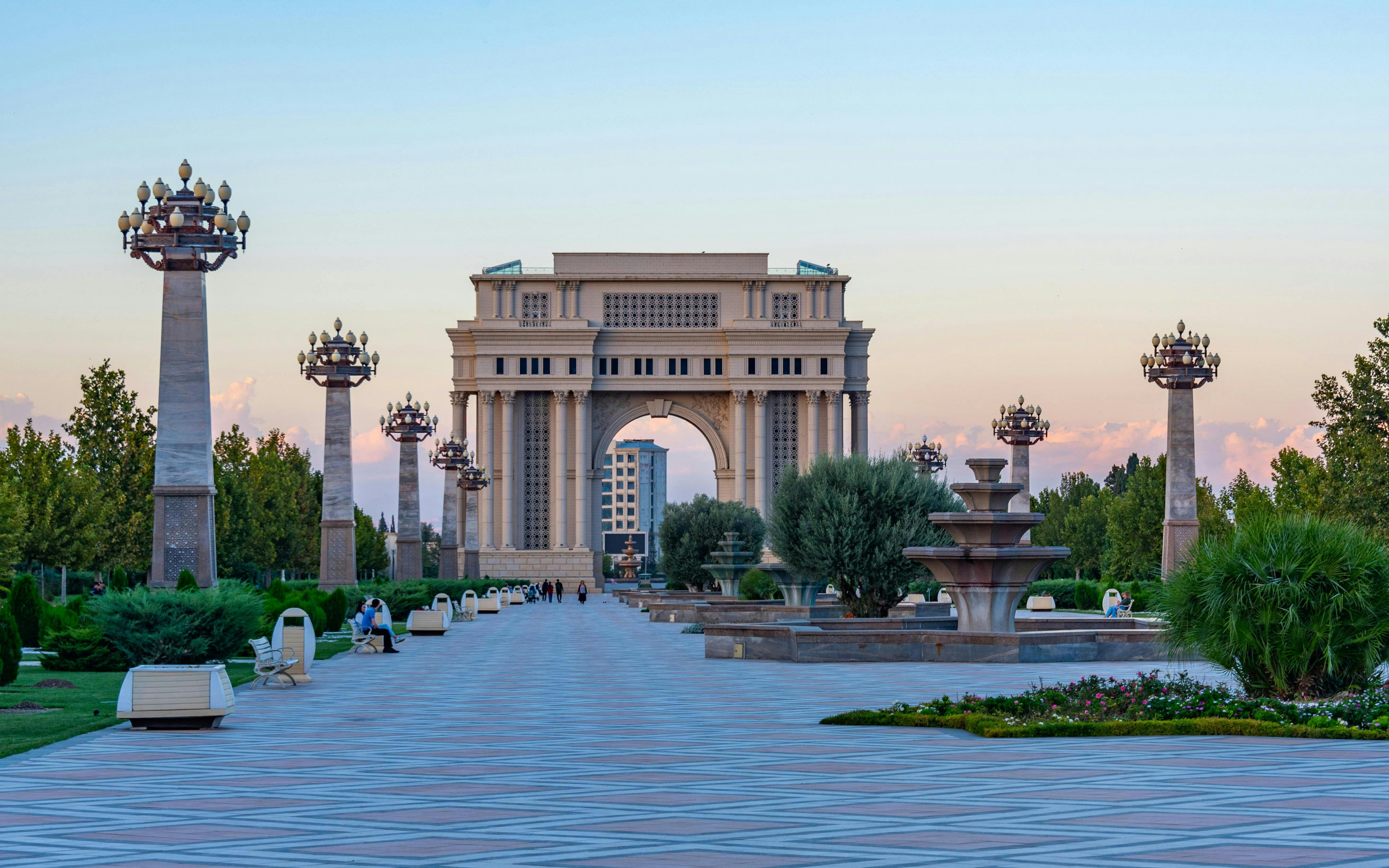 Triumphal arch in Heydar Aliyev Park, Ganja, Azerbaijan, with surrounding gardens and pathways.