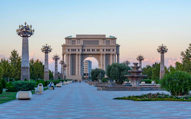 Triumphal arch in Heydar Aliyev Park, Ganja, Azerbaijan, with surrounding gardens and pathways.