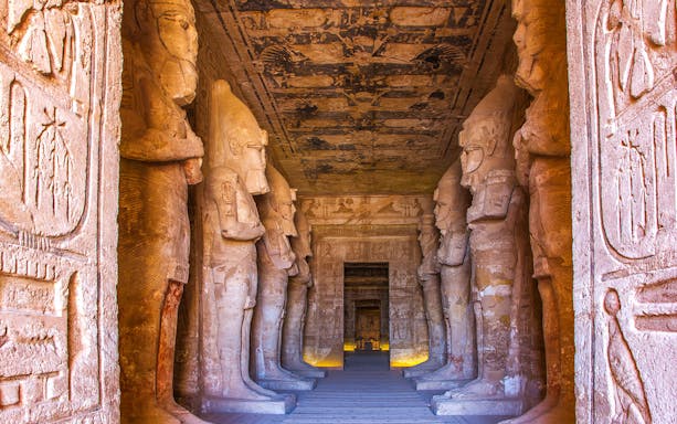 Abu Simbel temple interior with illuminated statues, Aswan, Egypt.