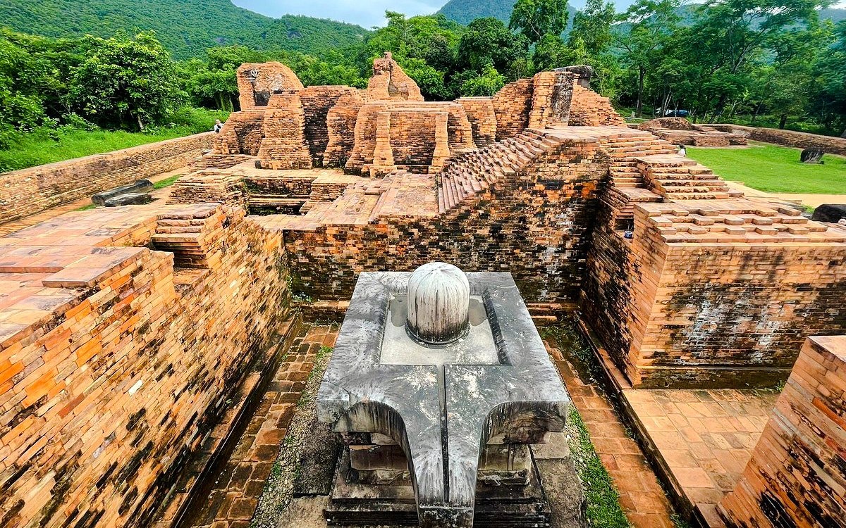 Ancient brick ruins at My Son Sanctuary, Vietnam, surrounded by lush greenery.