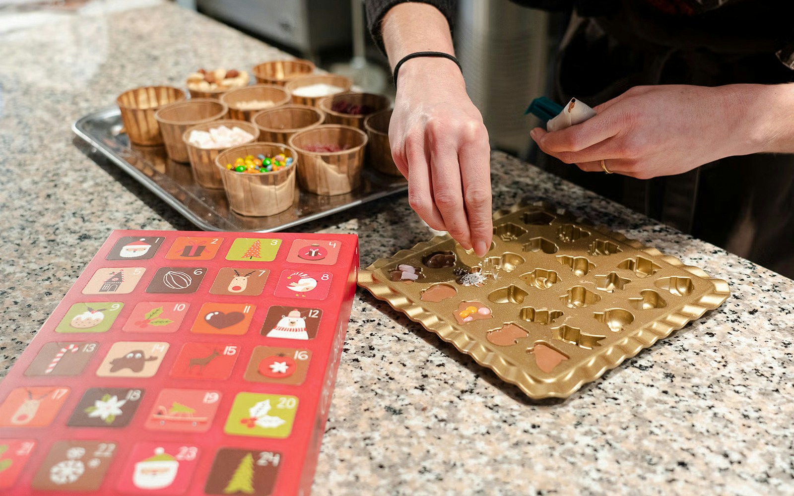 Creating chocolates at Choco-Story Brussels Museum with molds and toppings.