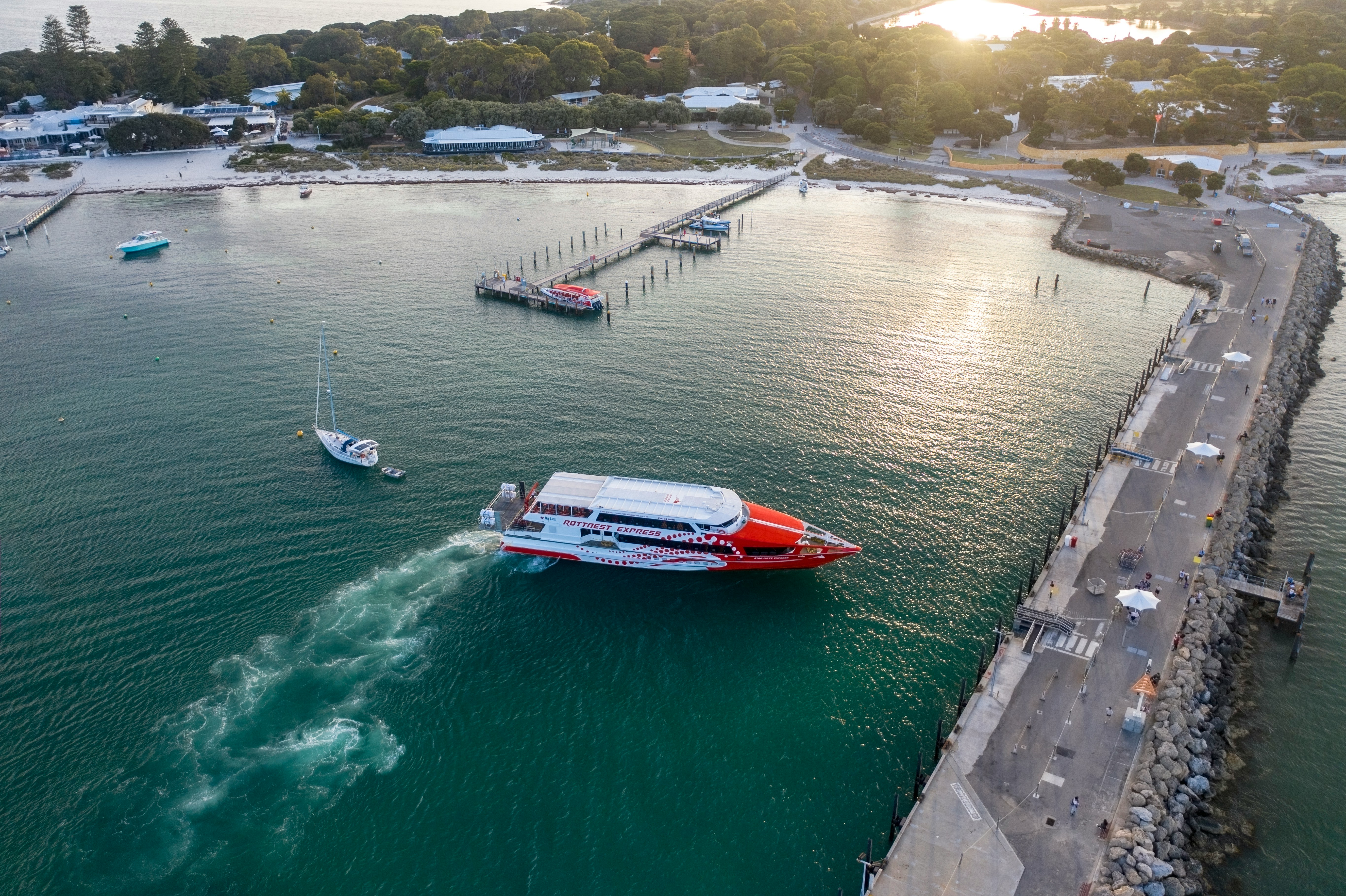 Rottnest Express ferry approaching jetty in turquoise waters, Rottnest Island.