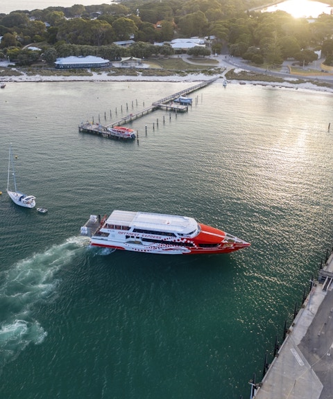 Rottnest Express ferry approaching jetty in turquoise waters, Rottnest Island.