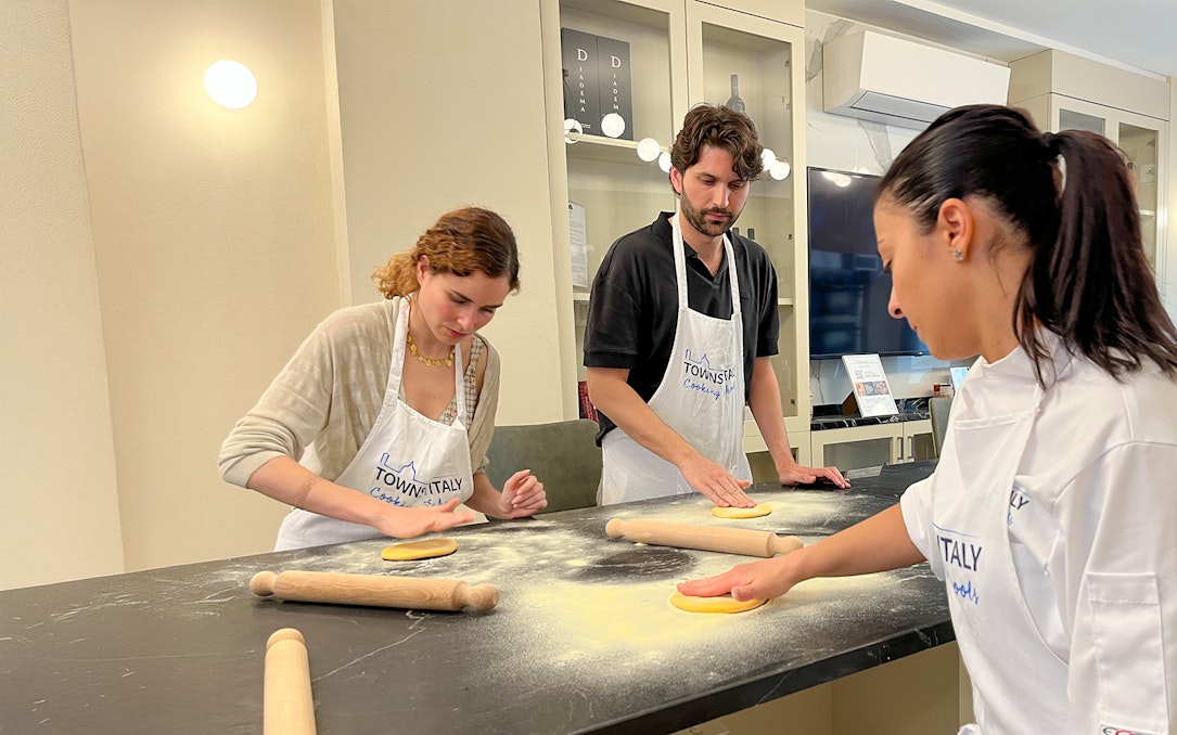 Participants making pasta in a Florence cooking class.