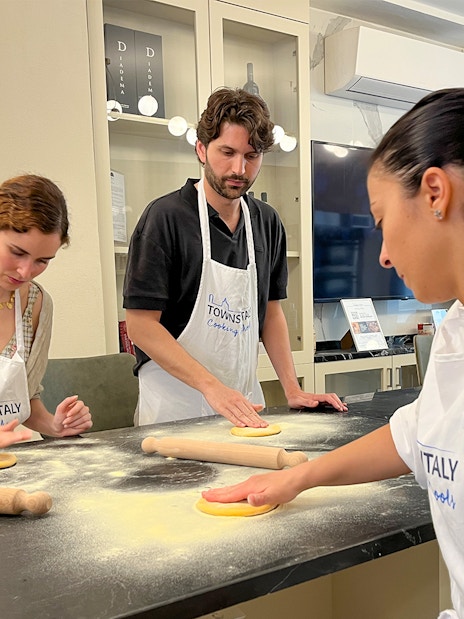 Participants making pasta in a Florence cooking class.