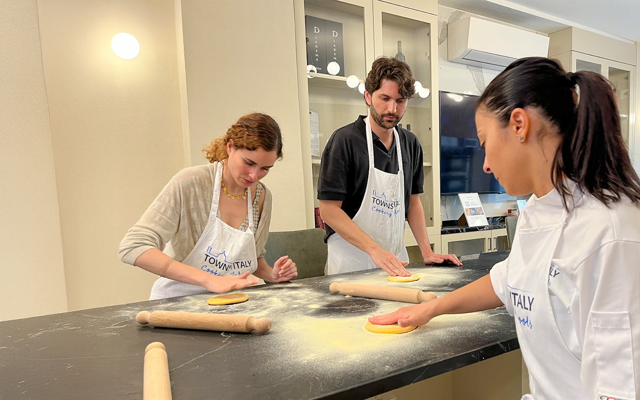 Participants making pasta in a Florence cooking class.