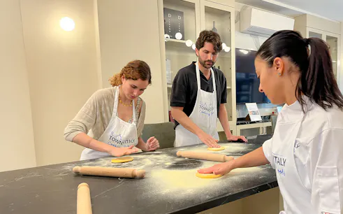 Participants making pasta in a Florence cooking class.