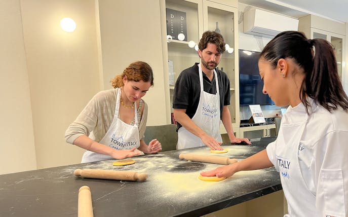 Participants making pasta in a Florence cooking class.
