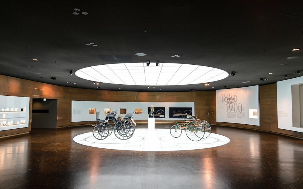 Historic vehicles displayed inside Mercedes Benz Museum.
