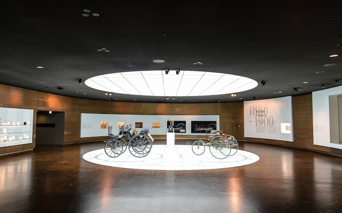 Historic vehicles displayed inside Mercedes Benz Museum.