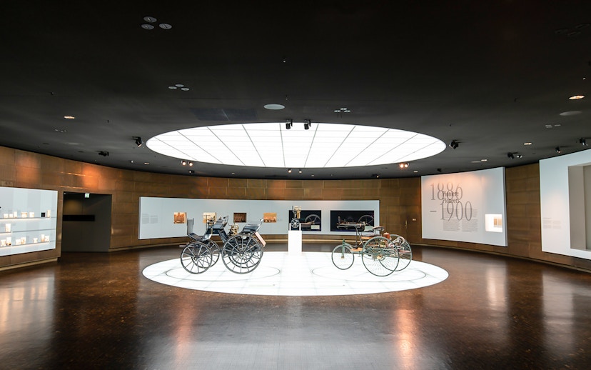 Historic vehicles displayed inside Mercedes Benz Museum.