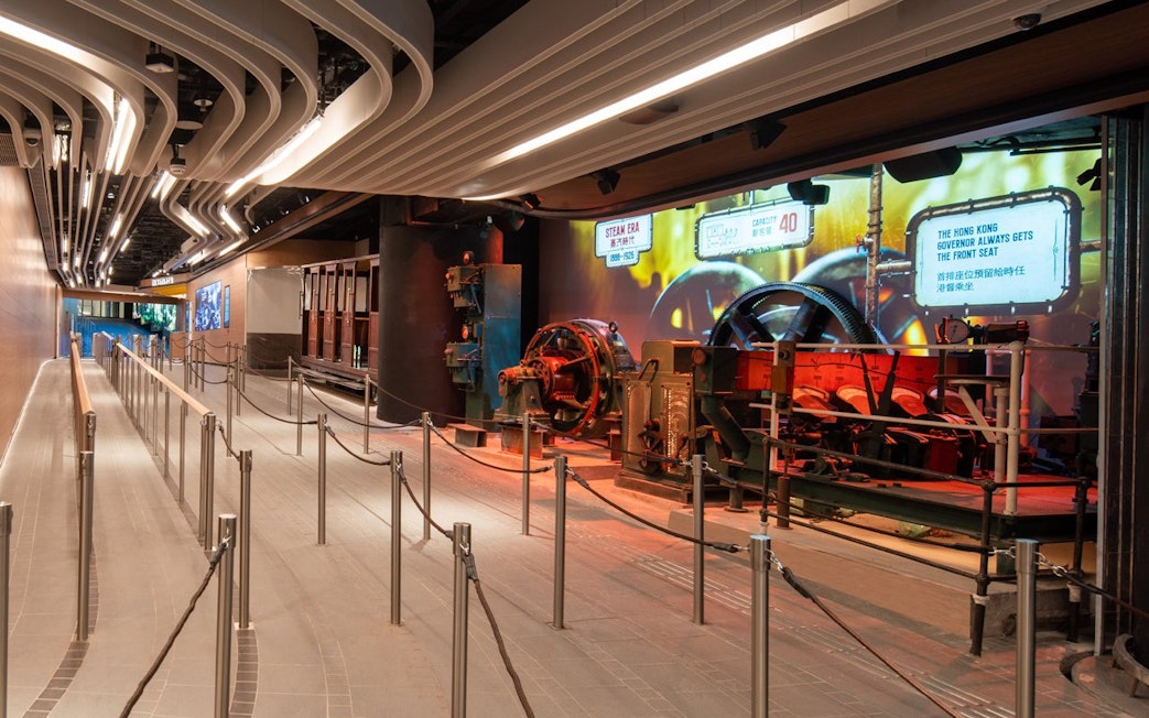Peak Tram waiting area with historical machinery display, Hong Kong.