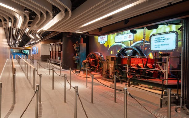 Peak Tram waiting area with historical machinery display, Hong Kong.