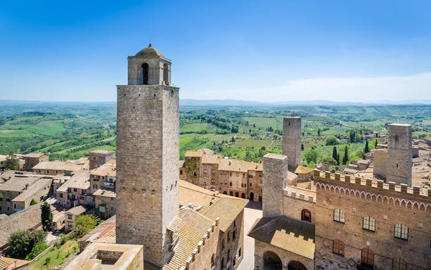 San Gimignano towers with Tuscan countryside in the background.