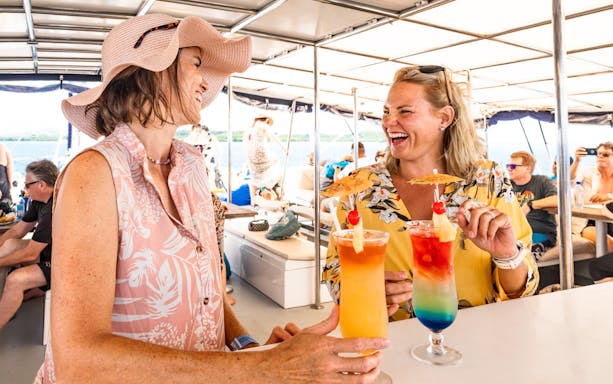Guests enjoying cocktails on the Sabre Sunset Cruise with BBQ dinner.
