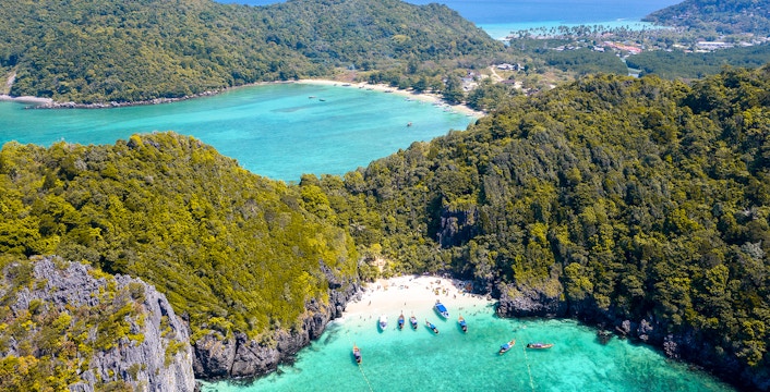 Aerial view of Phi Phi Island, Maya Bay with boats in turquoise waters, Thailand.