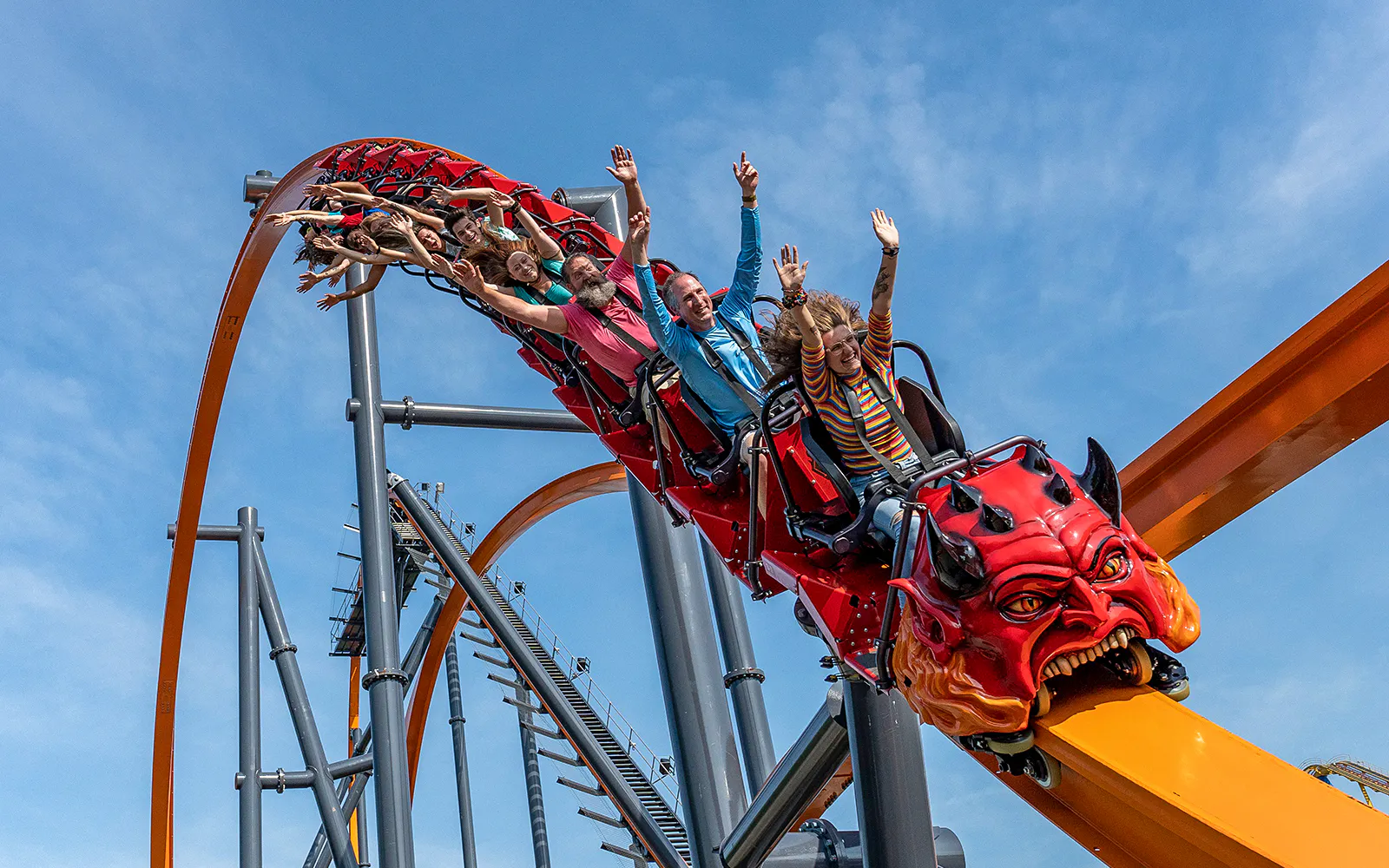 Roller coaster with riders at Six Flags Great Adventure, New Jersey.