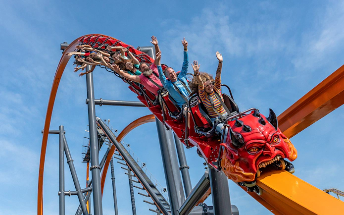 Roller coaster with riders at Six Flags Great Adventure, New Jersey.