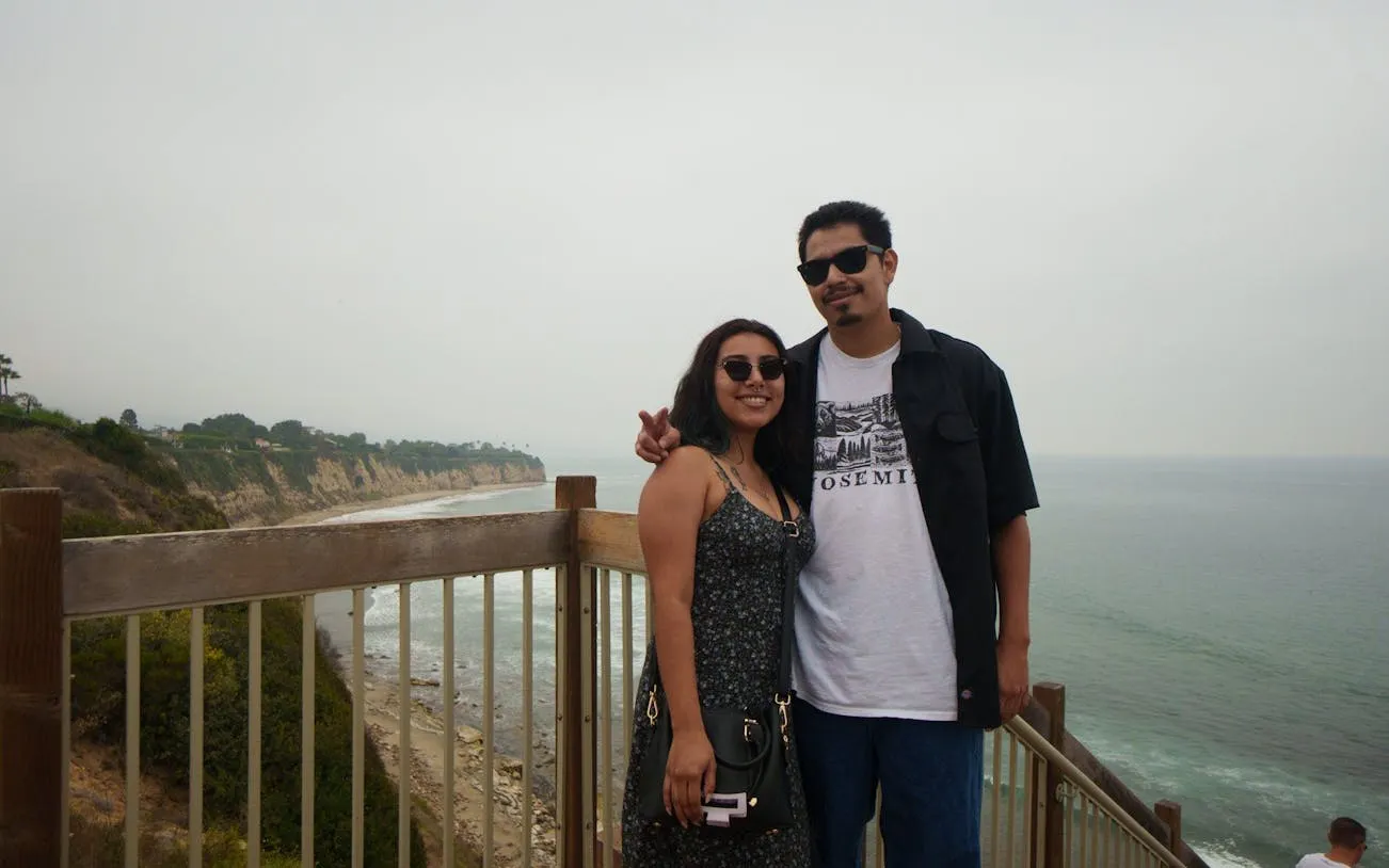 Couple on a coastal overlook with cliffs and ocean view, Santa Monica to Malibu tour.