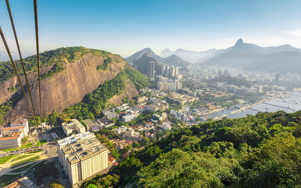 Cable car ascending Pao de Acucar with view of Rio de Janeiro, Brazil.