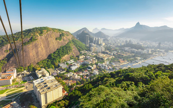 Cable car ascending Pao de Acucar with view of Rio de Janeiro, Brazil.