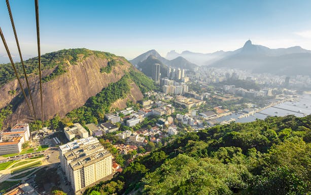 Cable car ascending Pao de Acucar with view of Rio de Janeiro, Brazil.