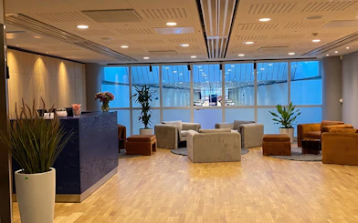 Pearl Lounge seating area with plants and reception at Stockholm Arlanda Airport Terminal 2.