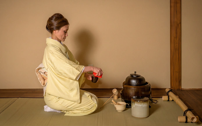 Person in kimono performing tea ceremony in Shinjuku.