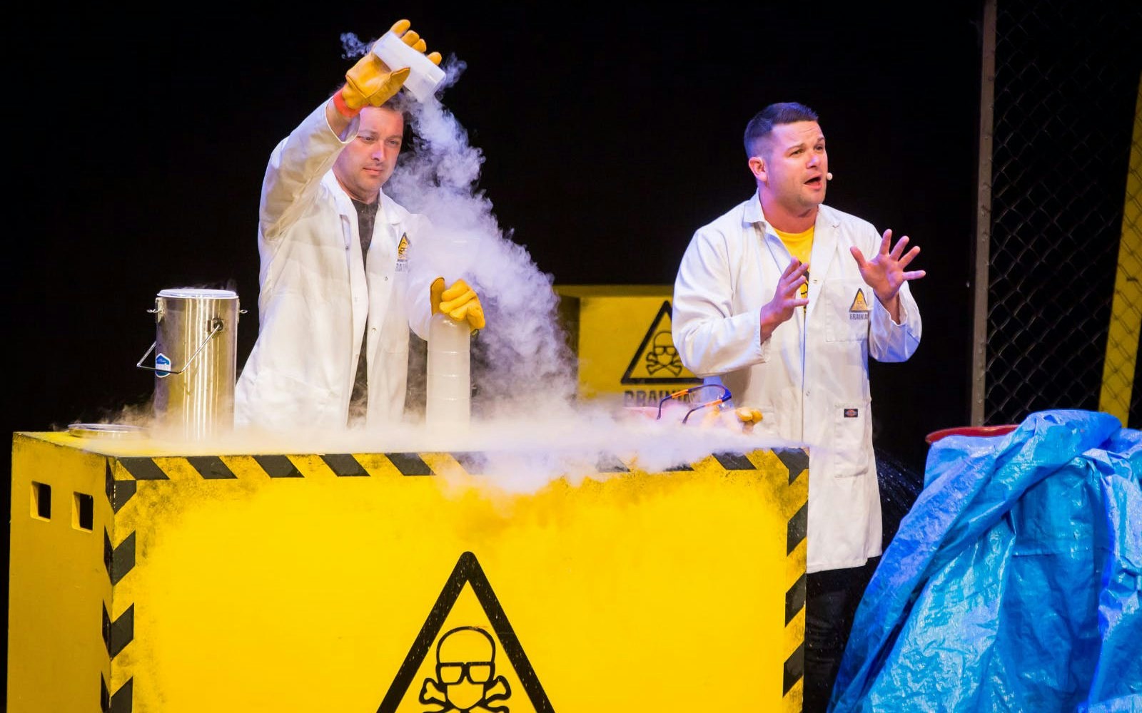 Scientists performing an experiment on stage at Brainiac Live Westend.