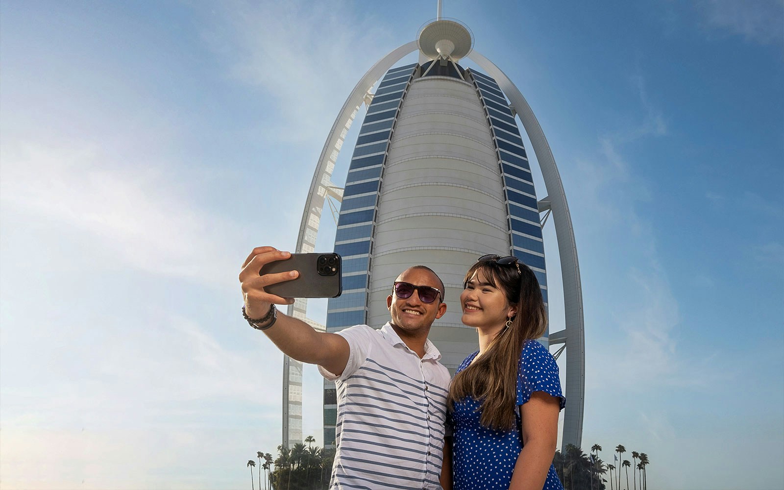 Tourists taking a selfie in front of Burj Al Arab during Inside Burj Al Arab Tour in Dubai.