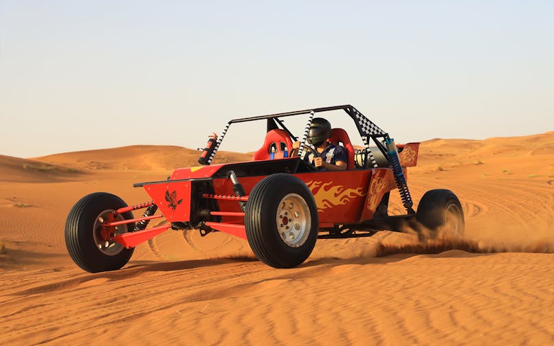 Dune buggy driving through Arabian desert during premium safari experience.