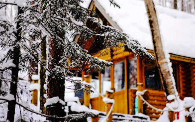 Snow-covered cabin and trees at Ningle Terrace, Hokkaido.