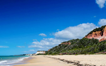 Sandy beach with cliffs in Arraial d'Ajuda, Porto Seguro, Brazil.