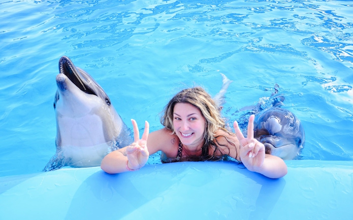 Swimming with dolphins at Dolphin World during a private photo experience.