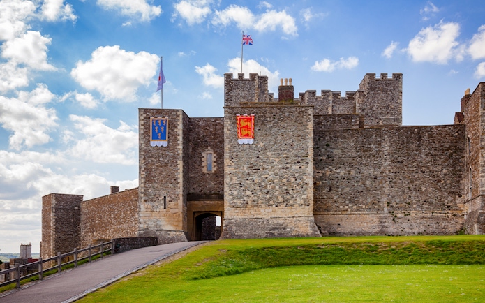 Dover Castle Inner Bailey wall with flags, Kent, Southern England, UK.
