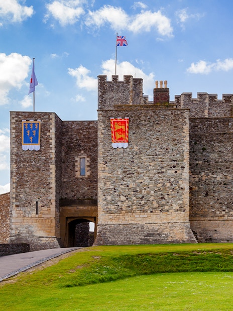 Dover Castle Inner Bailey wall with flags, Kent, Southern England, UK.
