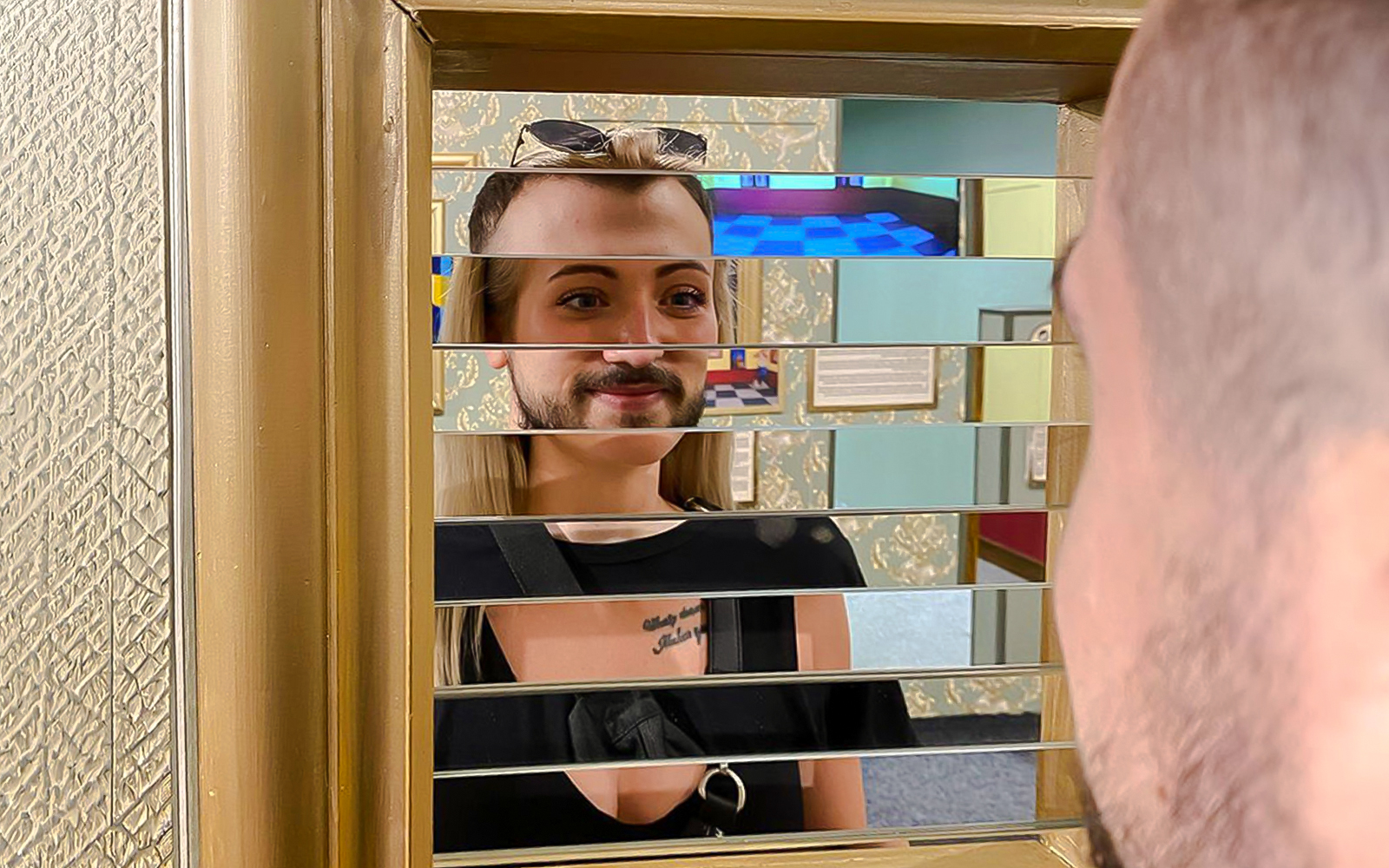 Person viewing optical illusion mirror at Museum of Fantastic Illusions.