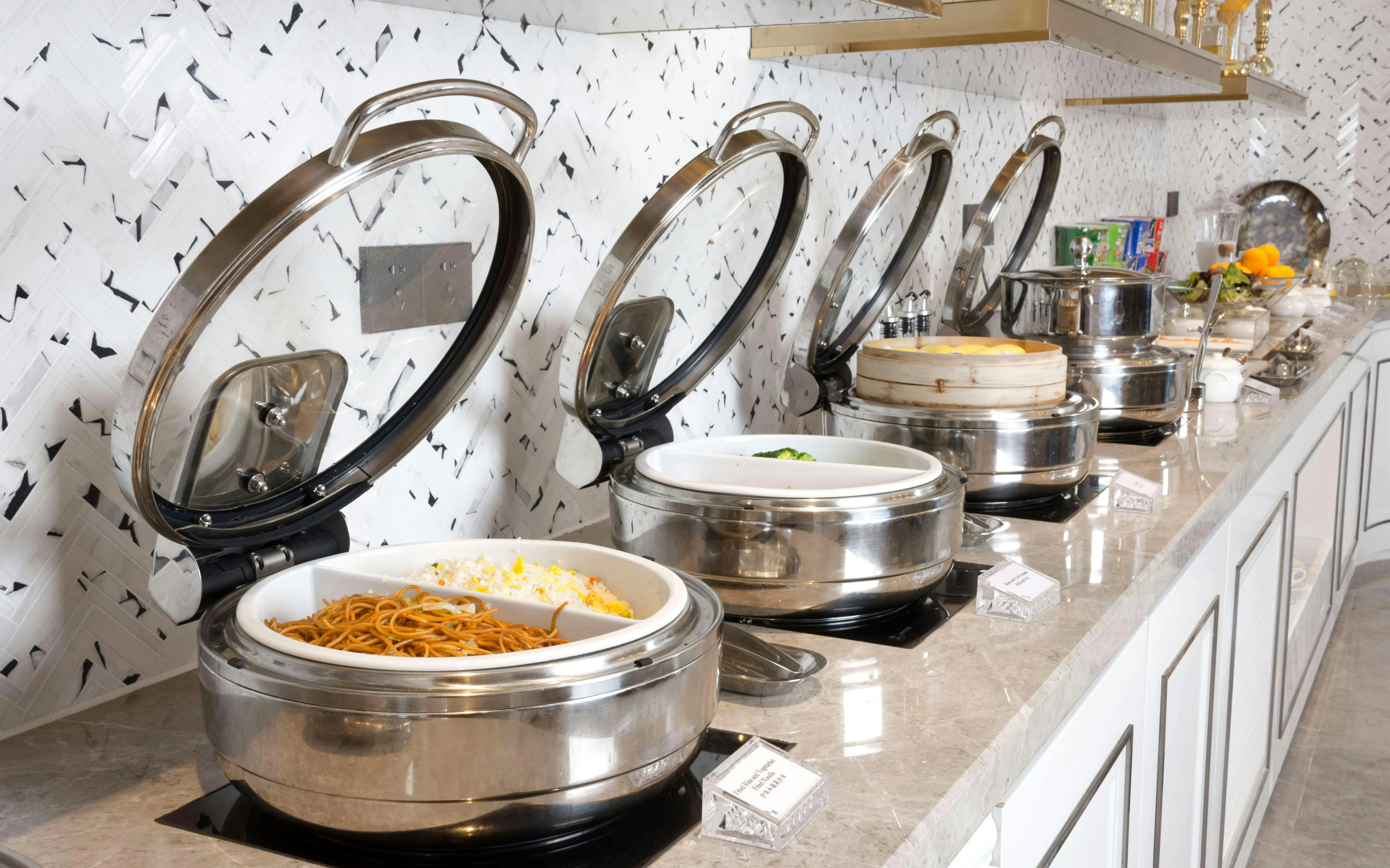 Buffet selection at Beijing Daxing International Airport Lounge with noodles and rice.
