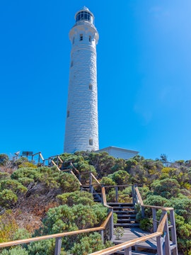 Margaret River Lighthouse with surrounding greenery and wooden walkway.