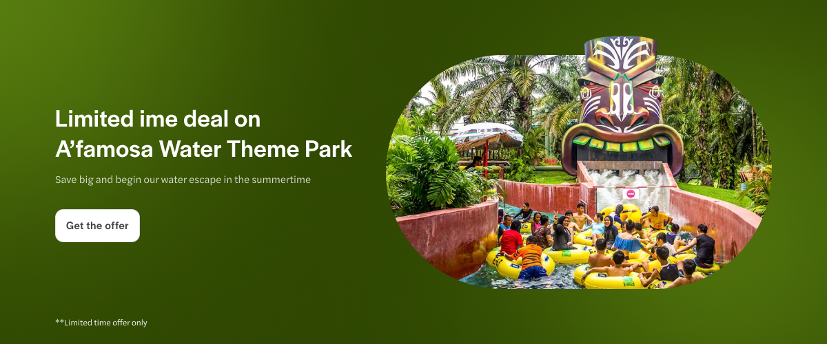 Rafting ride at A'famosa Water Park with tropical surroundings and tribal mask feature.