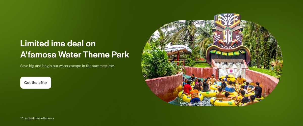 Rafting ride at A'famosa Water Park with tropical surroundings and tribal mask feature.